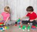 two-cute-boys-pink-red-t-shirts-playing-with-toys_179666-1380